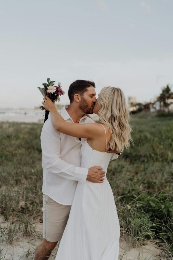 New married couple kissing each other on Saint Martin's beach